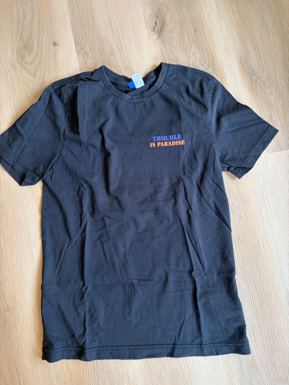 Divided Black Short Sleeve Tee with Orange 'Trouble in Paradise' Chest Print